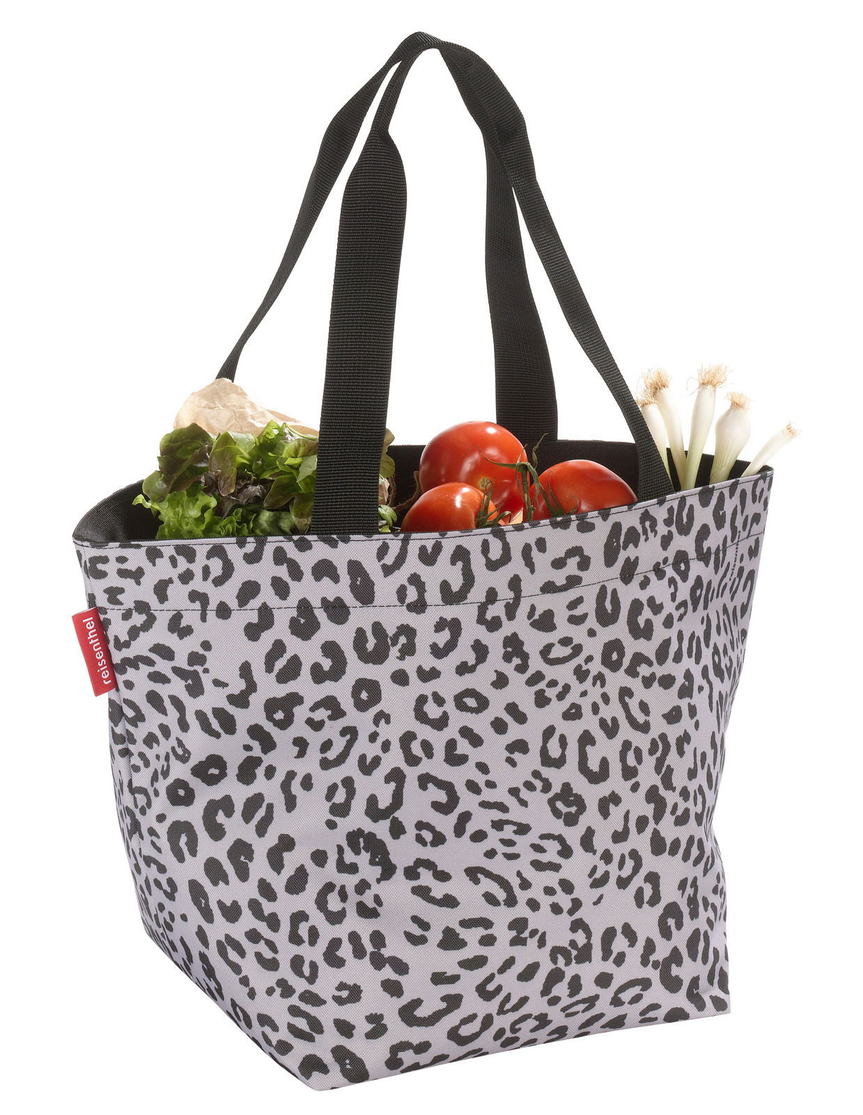 Leopardenmuster Shopper-Tasche mit schwarzen Griffen, gefüllt mit frischem Gemüse, seitliche Perspektive