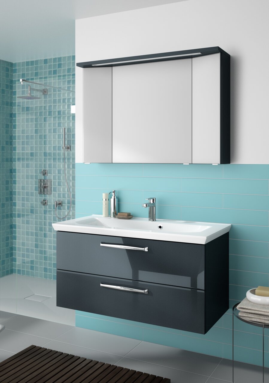 Pelipal Badblock 110cm TRENTINO Moderner Badblock mit zwei Schubladen und Waschbecken, frontal betrachtet, vor einer türkisfarbenen Fliesenwand.