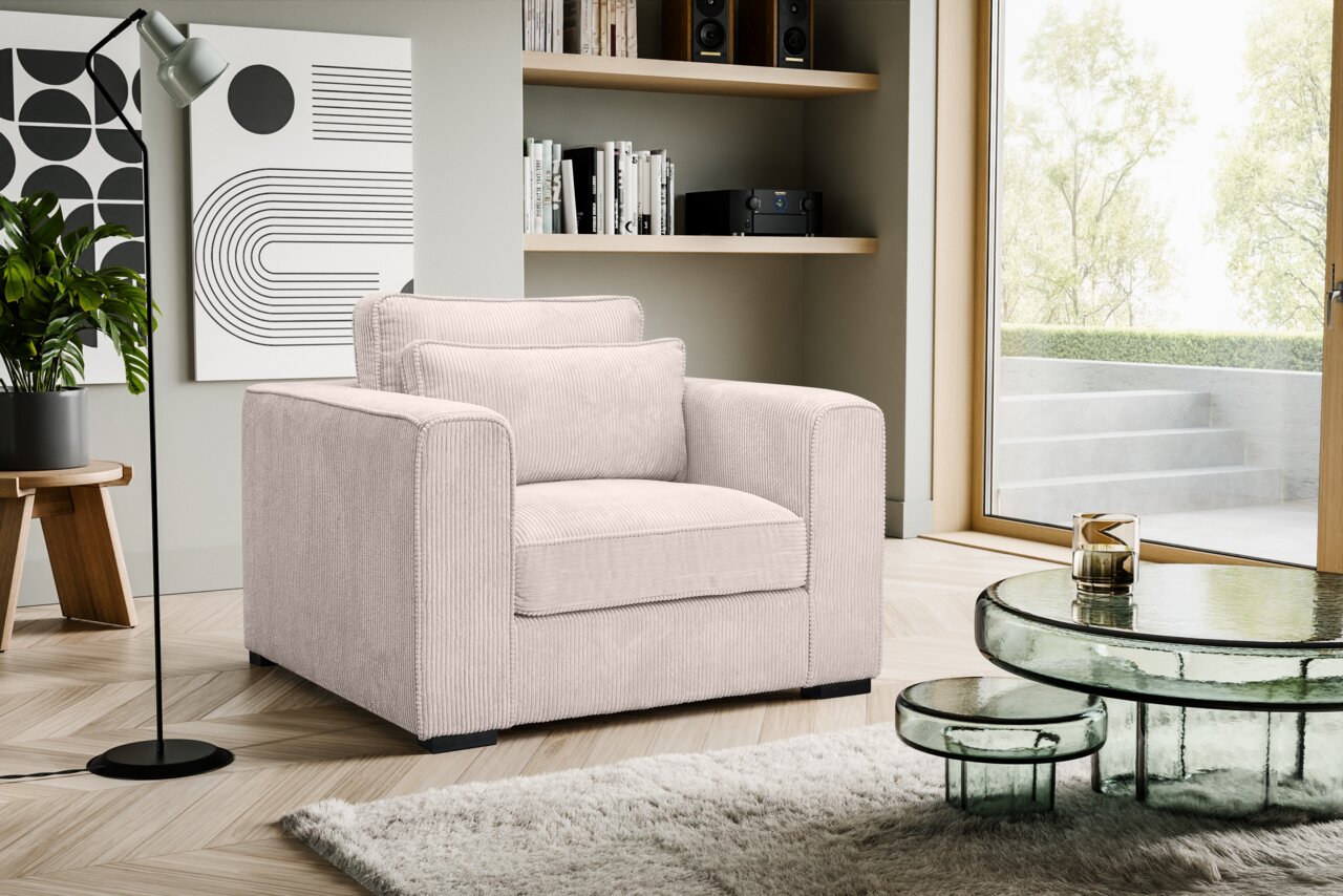 MID.YOU 1-Sitzer ALMERA Beiger, gerippter Cord-Sessel mit breiten Armlehnen und zwei Kissen im modernen Wohnzimmer, schräg von vorne links fotografiert.