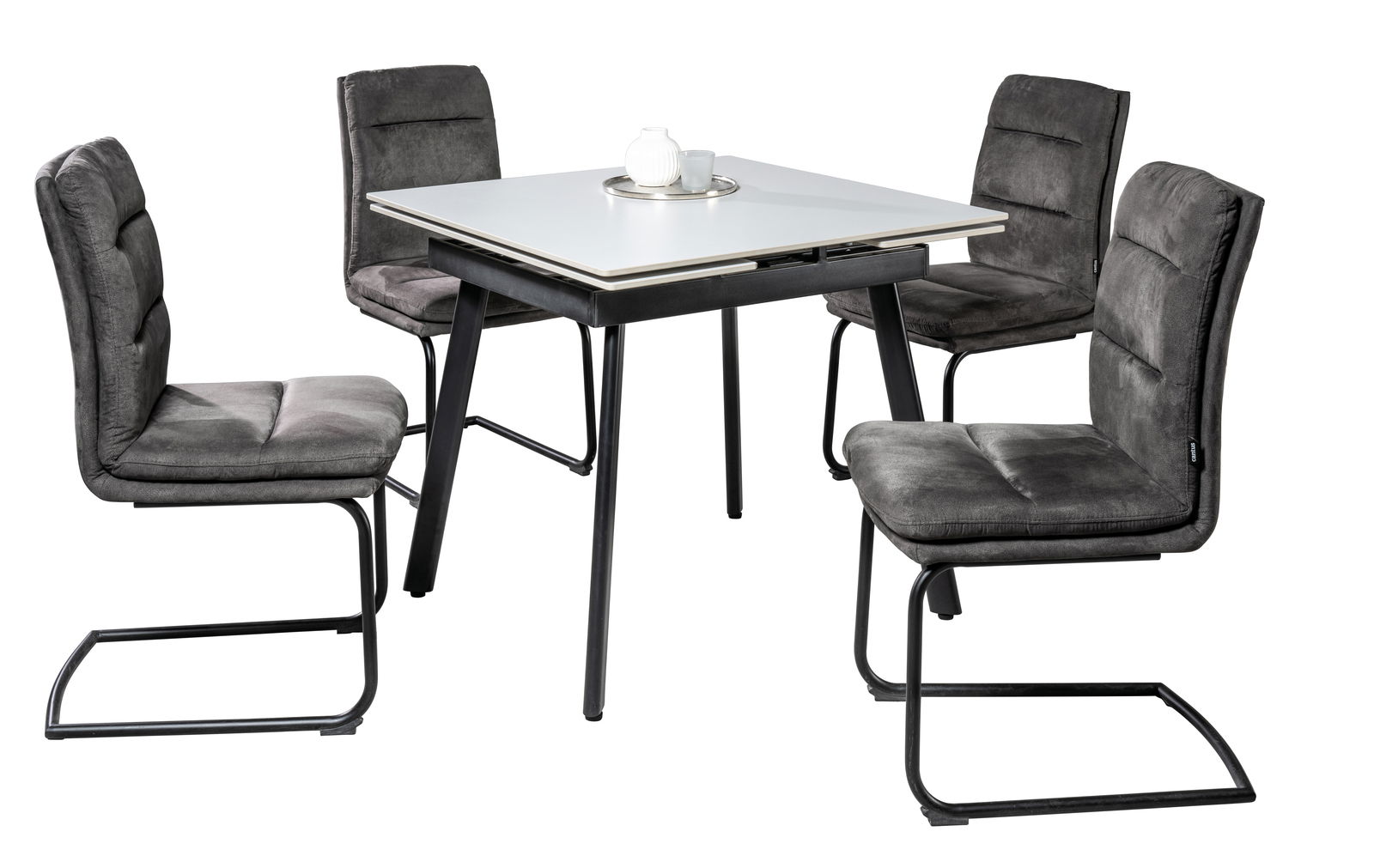 Essgruppe mit vier grauen Freischwinger-Stühlen und einem weißen Tisch, seitliche Perspektive