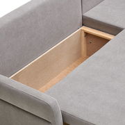 Detailansicht einer grauen Rundecke mit geöffneter Stauraumfunktion, von oben betrachtet.