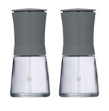 Zwei graue Mühlen aus Glas und Metall, frontal fotografiert, mit modernem Design.