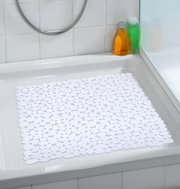 Douchemat Paradise White, gefotografeerd van bovenaf in een douchebak, met witte, druppelvormige patronen.