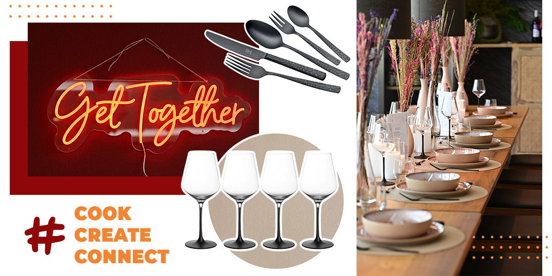 Wein- und Wassergläser, Besteckset und Leuchtschrift "Get Together" auf rotem Hintergrund