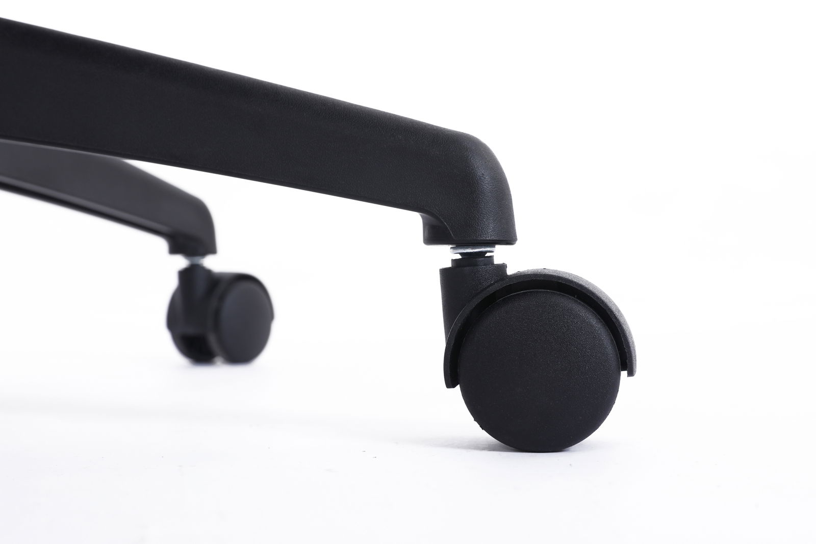 Nahaufnahme einer schwarzen Stuhlrolle eines Drehstuhls, seitliche Perspektive