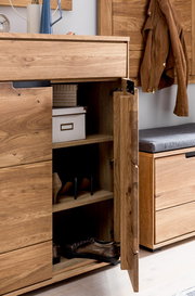 Offener Schuhschrank aus Holz mit mehreren Fächern, gefüllt mit Schuhen und einer Aufbewahrungsbox, aus seitlicher Perspektive fotografiert.