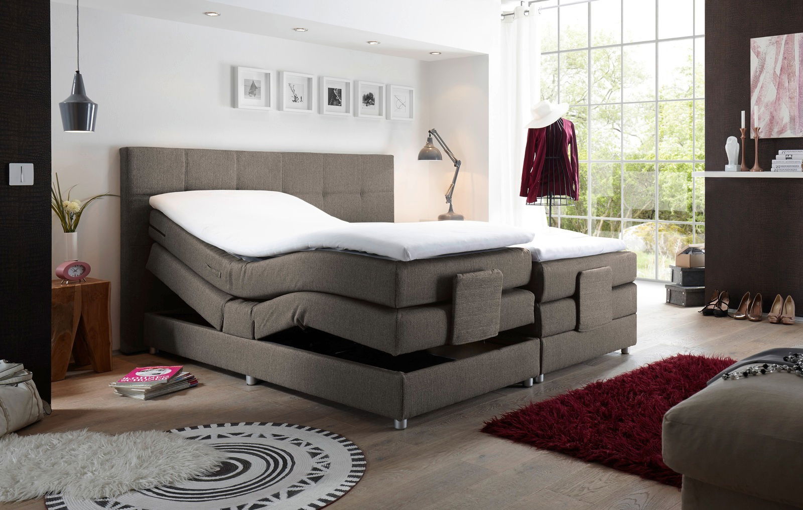 Boxspringbett mit verstellbaren Matratzen in einem modernen Schlafzimmer, seitliche Perspektive.