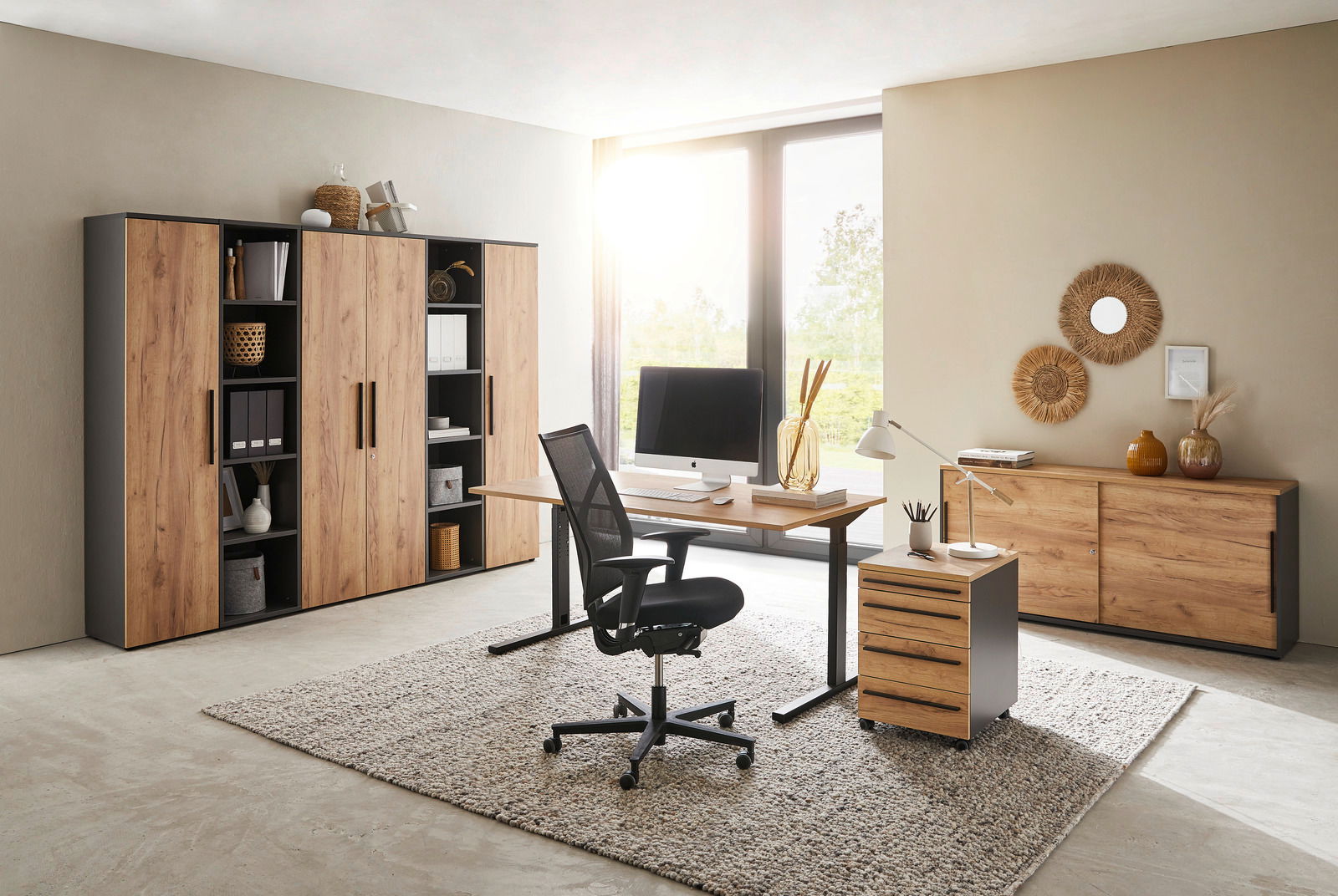 Novel Aktenschrank 5OH schmal RENTON Modernes Büro mit Holzmöbeln, bestehend aus einem Schreibtisch, einem Rollcontainer und mehreren Aktenschränken. Die Perspektive zeigt den Raum von vorne mit Blick auf das Fenster im Hintergrund.