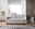 Modernes Schlafsofa in hellem Beige, frontal fotografiert, mit eleganten Armlehnen und einem gemütlichen Design, platziert in einem stilvollen Wohnzimmer mit Lampe und Beistelltischen.