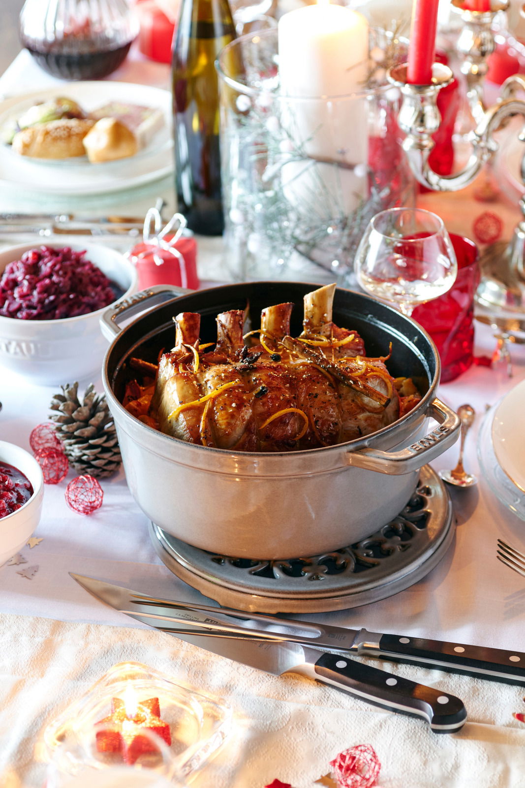 Runder Bräter Cocotte 24cm mit gebratenem Fleisch, auf einem festlich gedeckten Tisch von oben fotografiert.