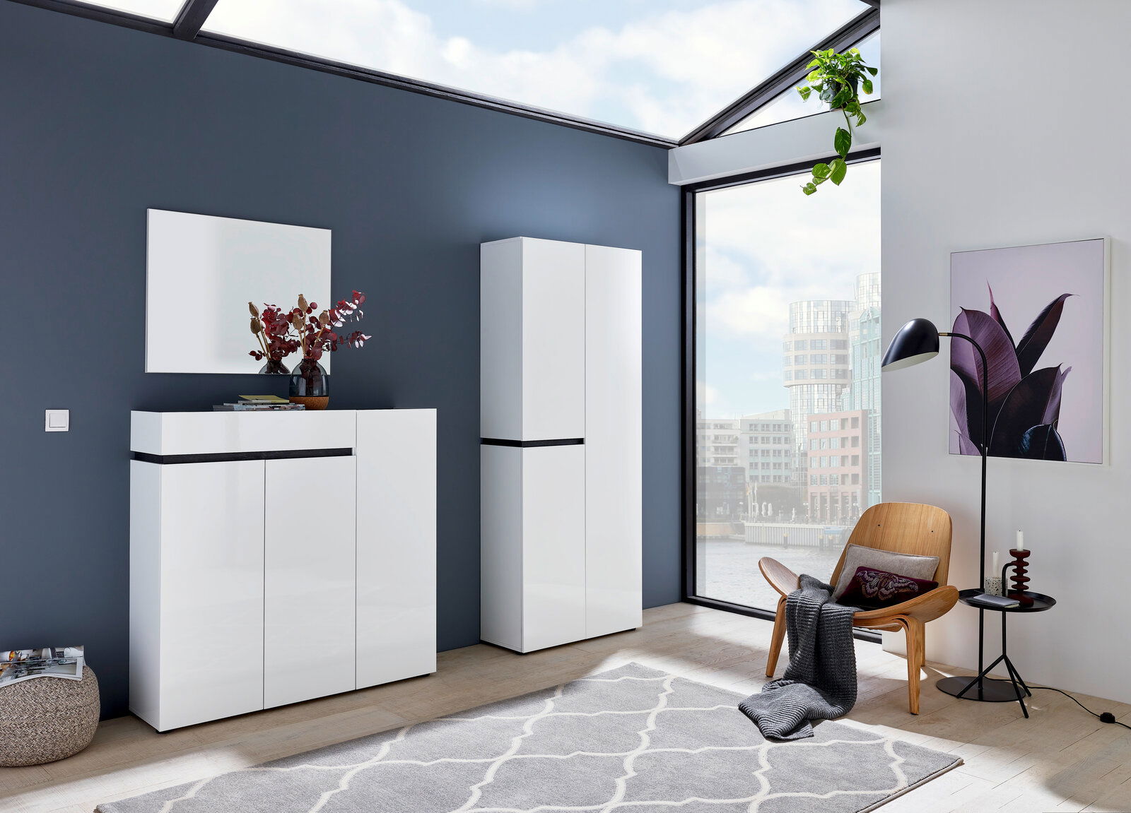 Voleo XL-Schuh-/Mehrzweckschrank YES Moderner weißer Schuhschrank und Garderobenschrank in einem hellen Raum mit großen Fenstern, seitliche Perspektive