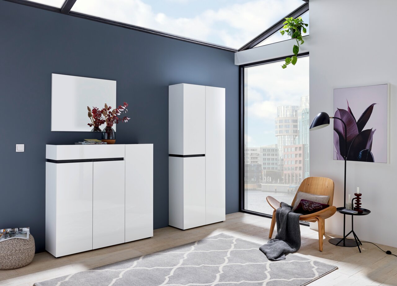 Voleo XL-Schuh-/Mehrzweckschrank YES Moderner weißer Schuhschrank und Garderobenschrank in einem hellen Raum mit großen Fenstern, seitliche Perspektive