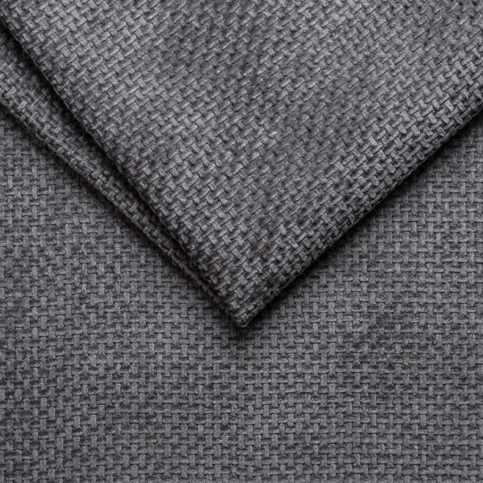 Nahaufnahme eines grauen, strukturierten Stoffes, der für ein Polsterbettgestell verwendet wird.