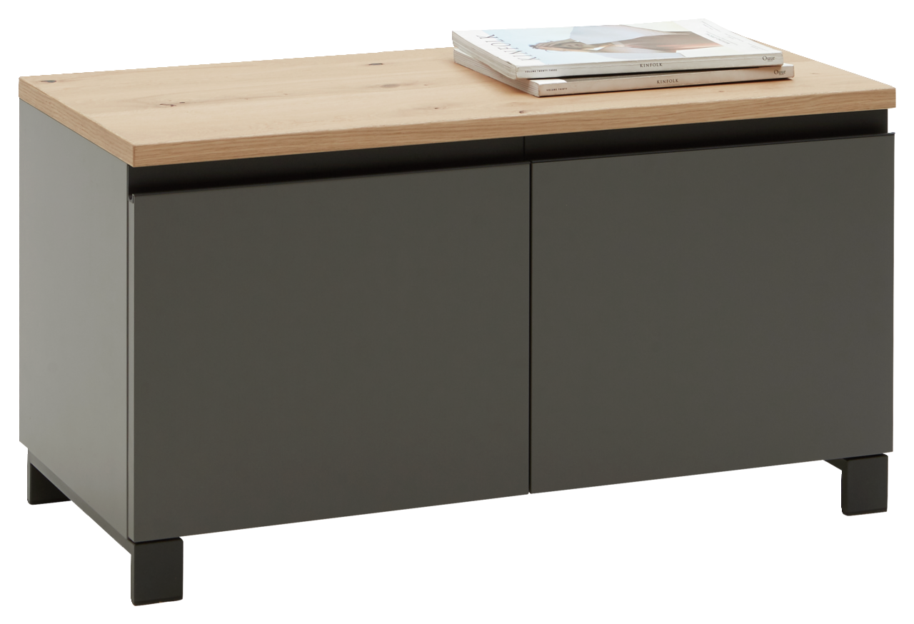 Dieter Knoll Garderobenbank SORRENT Garderobenbank der Serie SORRENT von Dieter Knoll in einer schrägen Perspektive. Die Bank hat eine dunkle Front mit zwei Türen und eine helle Holzoberfläche, auf der Zeitschriften liegen.