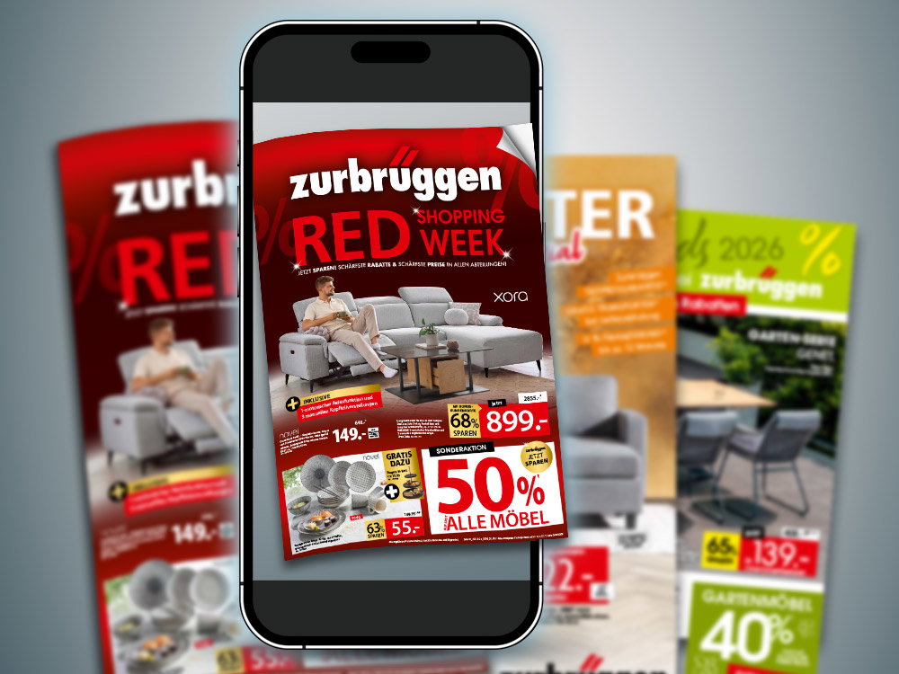 Smartphone mit Zurbrüggen Red Week Prospekt und weiteren Angebotsprospekten im Hintergrund.