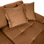 Nahaufnahme einer braunen Rundecke mit zwei Kissen, von oben betrachtet.