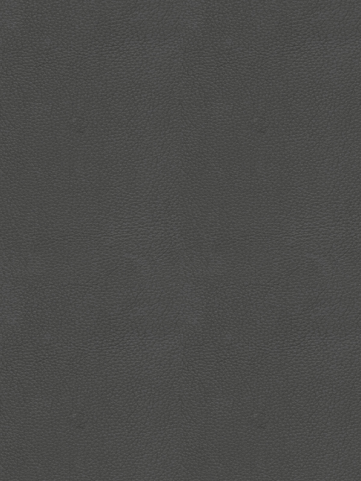 Nahaufnahme in Draufsicht: dunkelgraue, fein genarbte Leder- bzw. Kunstleder-Oberfläche als strukturierter Hintergrund