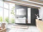 Moderne Badkombination mit weißem Waschtisch und Spiegelschrank, seitlich von einem hohen Schrank flankiert, in einem hellen Badezimmer mit großen Fenstern und Holzbalkendecke, Perspektive von vorne.