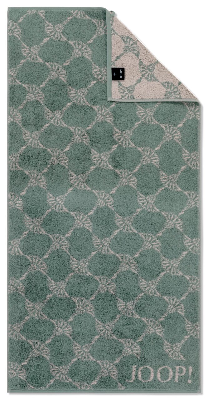 Grünes Handtuch mit geometrischem Muster und JOOP!-Logo, aus der Vogelperspektive fotografiert.