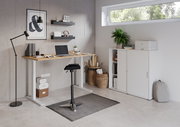 Moderner E-Schreibtisch in einem stilvollen Büro mit Blick von vorne, ausgestattet mit Laptop, Pflanzen und Regalen.