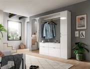 Moderne weiße Kommode in einem stilvollen Wohnzimmer, frontal betrachtet, mit hängender Kleidung und Dekoration.