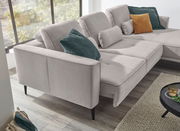 Graues Ecksofa mit mehreren Kissen in verschiedenen Farben, seitliche Perspektive.