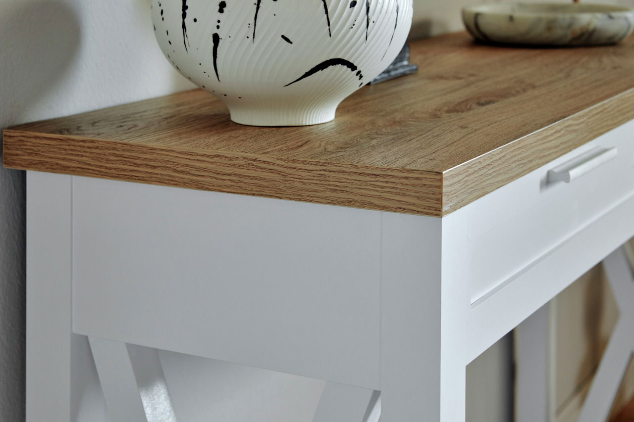 Nahaufnahme einer Konsole mit weißem Korpus und Holzoberfläche, dekoriert mit einer Vase. Perspektive von schräg oben.