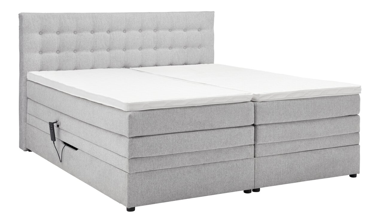 Graues Boxspringbett mit gepolstertem Kopfteil, seitlicher Perspektive