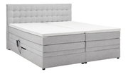 Graues Boxspringbett mit gepolstertem Kopfteil, seitlicher Perspektive