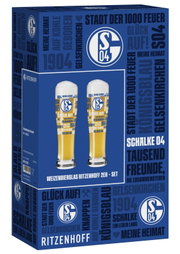 Ritzenhoff Weizenbierglas-Set mit zwei FC-Schalke-04-Fanmotiven in blau-gelbem Design, gezeigt in der blau bedruckten Geschenkverpackung aus schräger Vorderansicht.