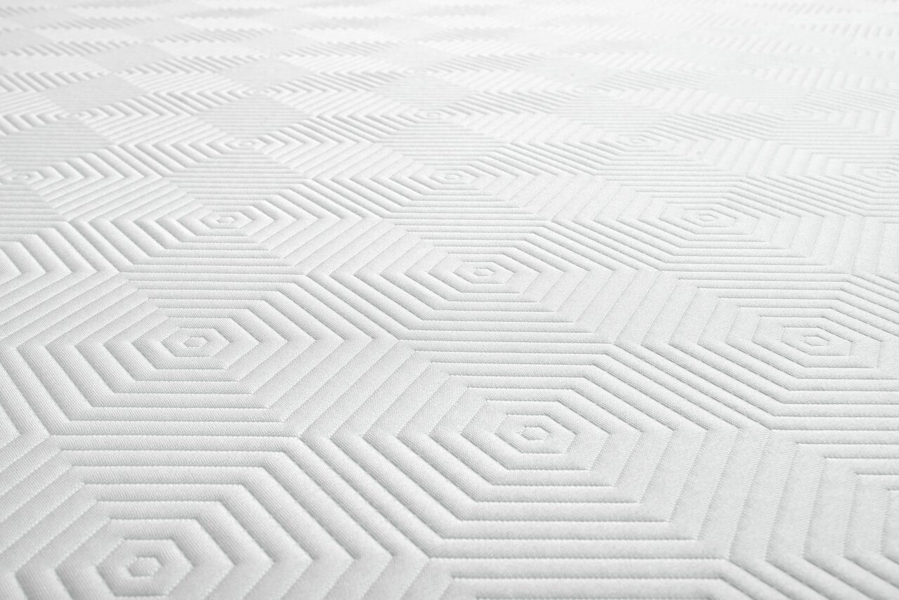 Close-up van een Viscoma-matras met een geometrisch patroon in het wit.