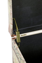 Detailaufnahme aus seitlicher Nahansicht: geöffneter Koffer/Truhe mit Vintage-Print außen, schwarzem Innenfutter und goldfarbenem Metallverschluss mit Scharnier.