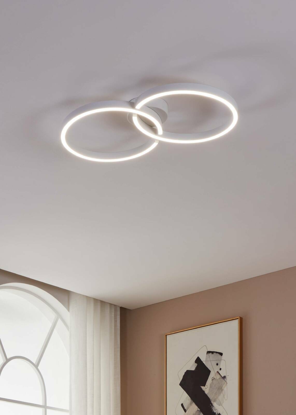 Moderne Deckenleuchte AMANDOLO mit zwei ineinander verschlungenen LED-Ringen, von unten betrachtet.