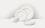 Weißes Tafelservice 16-tlg. mit strukturiertem Rand, bestehend aus zwei Tellern, einer Schale und einem tiefen Teller, aus seitlicher Perspektive fotografiert.