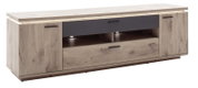 Modernes TV-Lowboard in heller Holzoptik mit zwei Türen, Schublade und offenen Fächern samt LED-Beleuchtung, schwarz abgesetzter Front und Metallgriffen, schräg von vorne links fotografiert