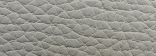 Bacher Sessel KAMA Nahaufnahme einer grauen, strukturierten Polsteroberfläche eines Sessels.