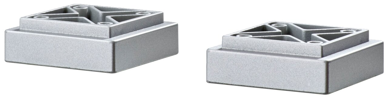 Zwei silberne, quadratische Füße aus Metall, perspektivisch von der Seite fotografiert.