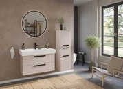 Modernes Waschtisch-Set in einem stilvollen Badezimmer mit runder Spiegelansicht, eleganten Schränken und natürlichem Lichteinfall.