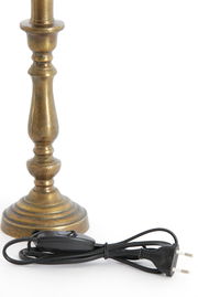 Nahaufnahme eines antik aussehenden Lampenfußes aus Metall mit einem schwarzen Kabel und Schalter.