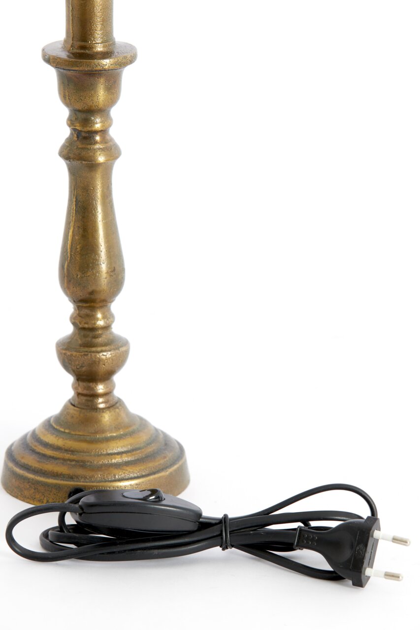 Nahaufnahme eines antik aussehenden Lampenfußes aus Metall mit einem schwarzen Kabel und Schalter.