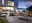 Modernes Lounge-Set auf einer Terrasse mit Blick auf einen See bei Sonnenuntergang, seitliche Perspektive.