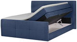 Blaues Boxspringbett mit hochgeklappter Matratze und sichtbarem Stauraum, seitliche Perspektive
