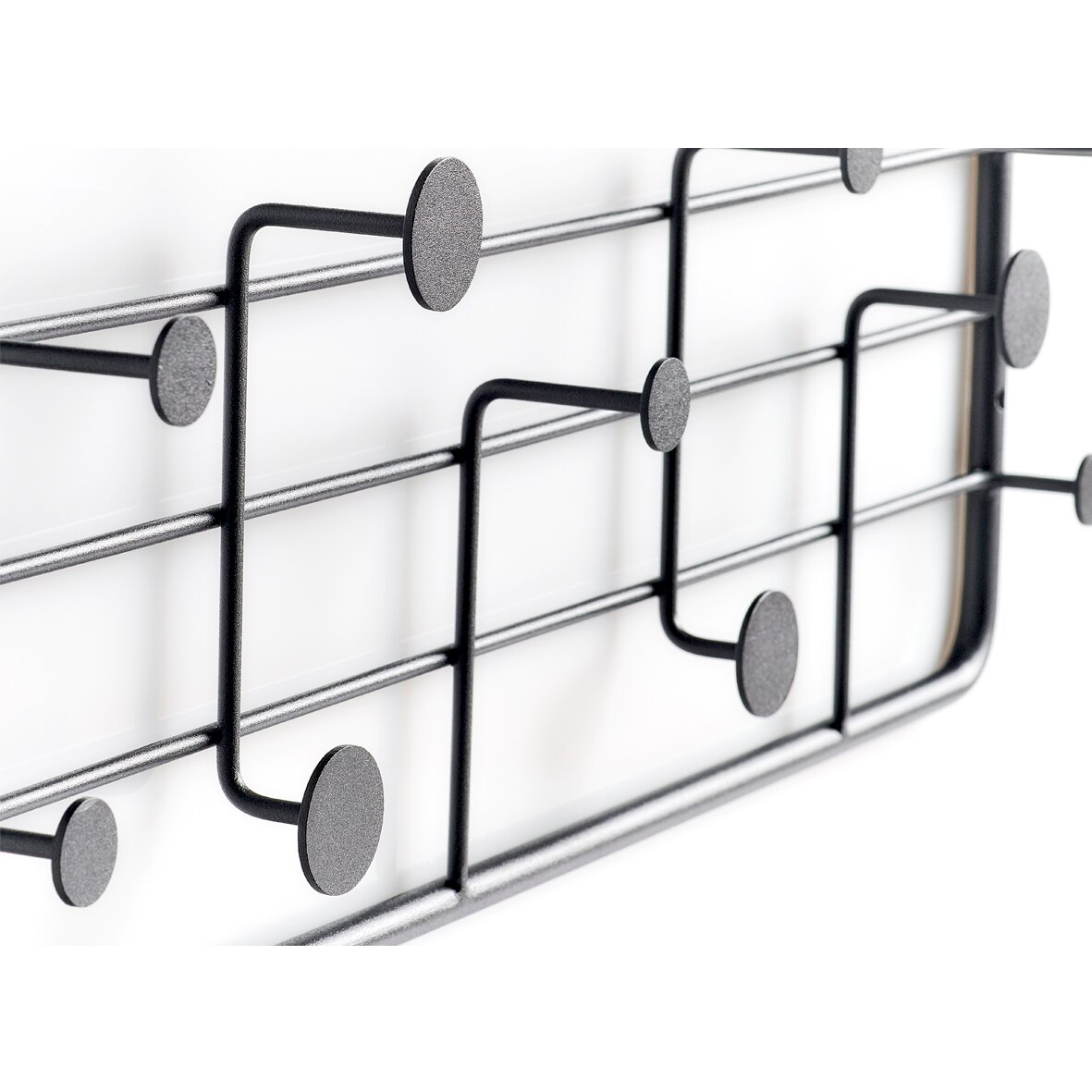 Nahaufnahme einer modernen Wandgarderobe aus Metall mit mehreren Haken in einem geometrischen Design, seitliche Perspektive.