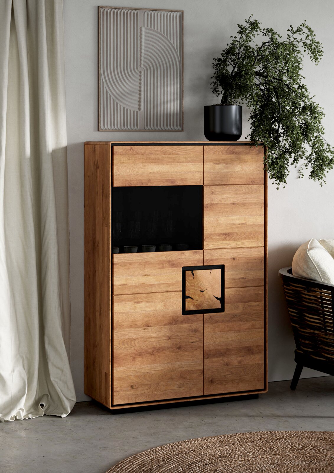 Moderne hohe Holzkommode/Highboard in Eiche-Optik mit schwarzem offenen Fach und dekorativem Einsatz, fotografiert in leichter Schrägansicht von vorne in einem hellen Wohnraum.
