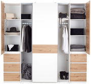 Moderner Dreh- und Schwebetürenschrank mit vier Türen, in Weiß und Holzoptik, gefüllt mit Kleidung und Accessoires, frontal betrachtet.