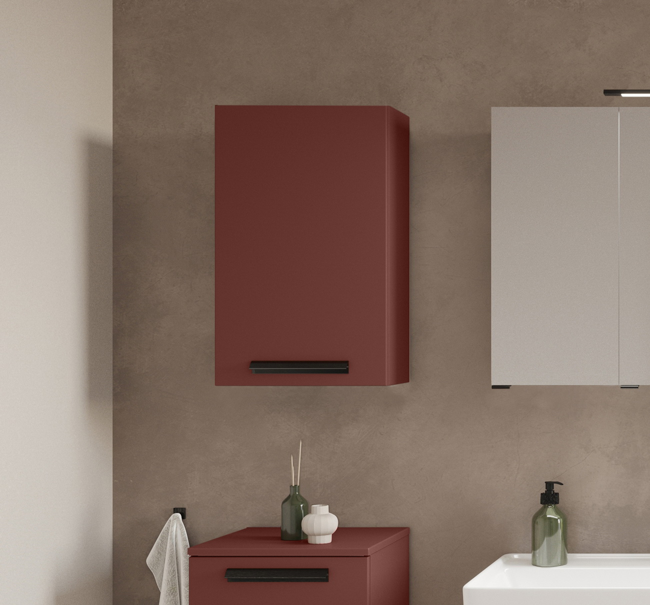 Moderner Hängeschrank in Rot mit schwarzem Griff, frontal betrachtet, neben einem weißen Schrank und über einem Waschbecken platziert.