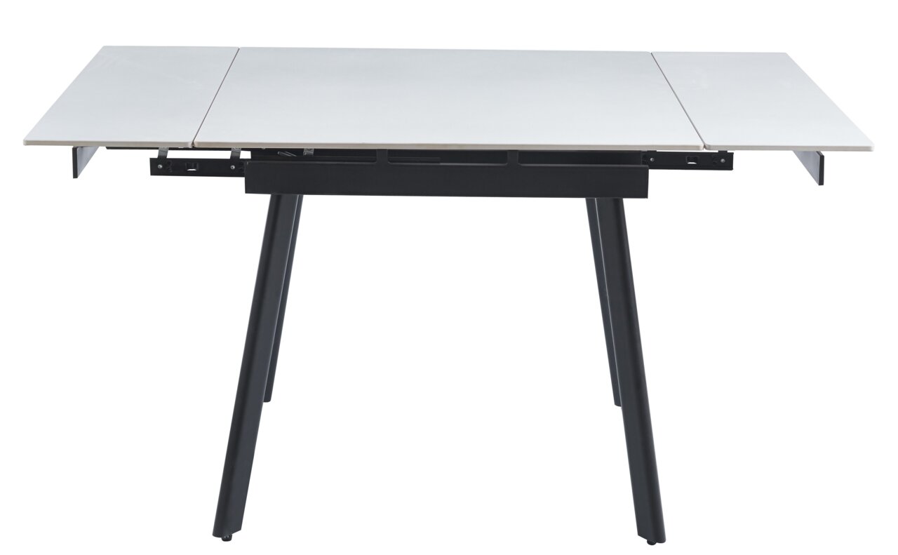 Moderner Esstisch mit ausziehbarer weißer Tischplatte und schwarzen Beinen, seitliche Perspektive.