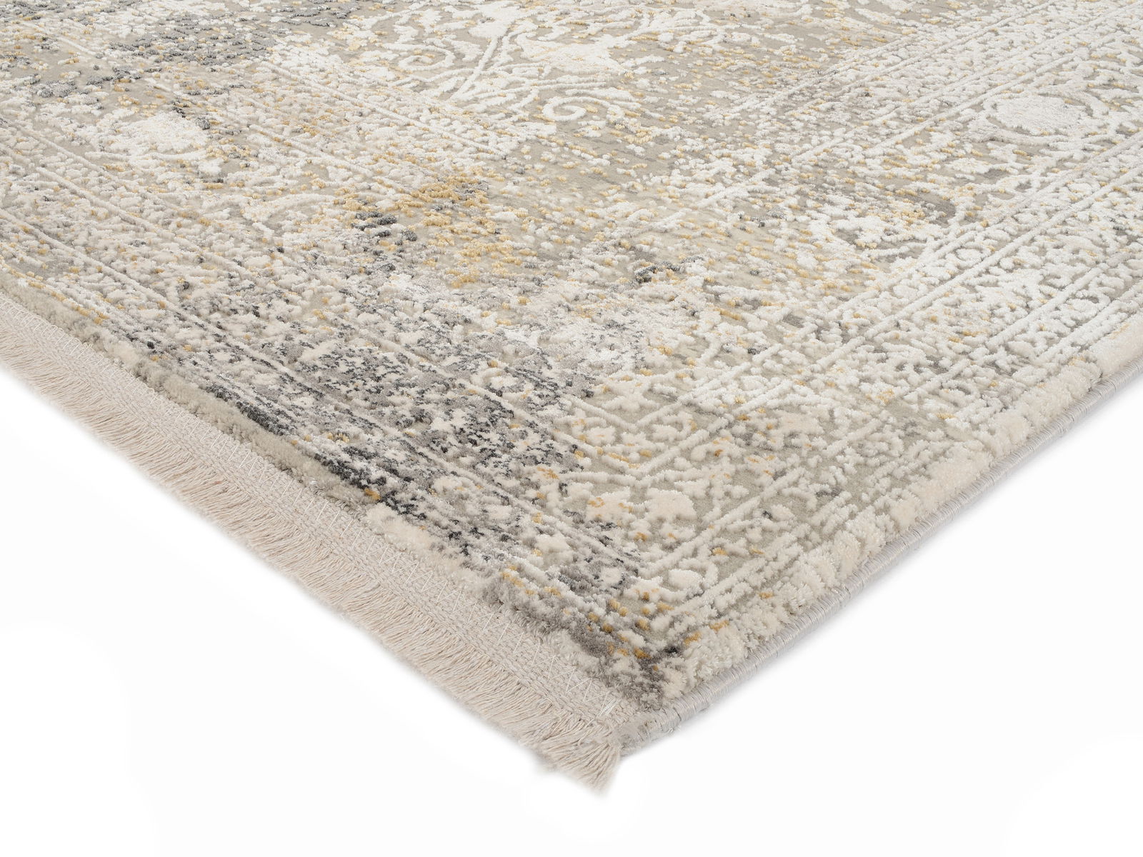 Nahaufnahme eines Designer-Teppichs mit detailliertem Muster in Grau- und Beigetönen, perspektivisch von der Ecke aufgenommen.