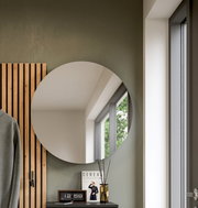 Runder Wandspiegel in modernem Interieur, seitliche Perspektive