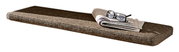 Braunes Sitzkissen in rechteckiger Form, seitliche Perspektive, mit einer Zeitung und einer Brille darauf.